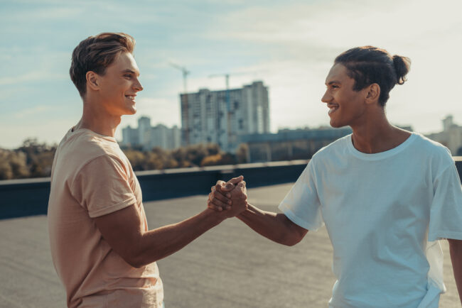 young men shaking hands